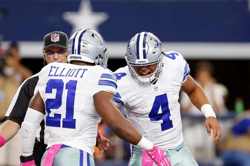 Dallas Cowboys quarterback Dak Prescott (4) congratulates Dallas Cowboys running back...