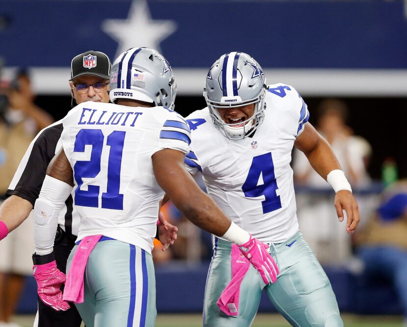 Dallas Cowboys quarterback Dak Prescott (4) congratulates Dallas Cowboys running back...