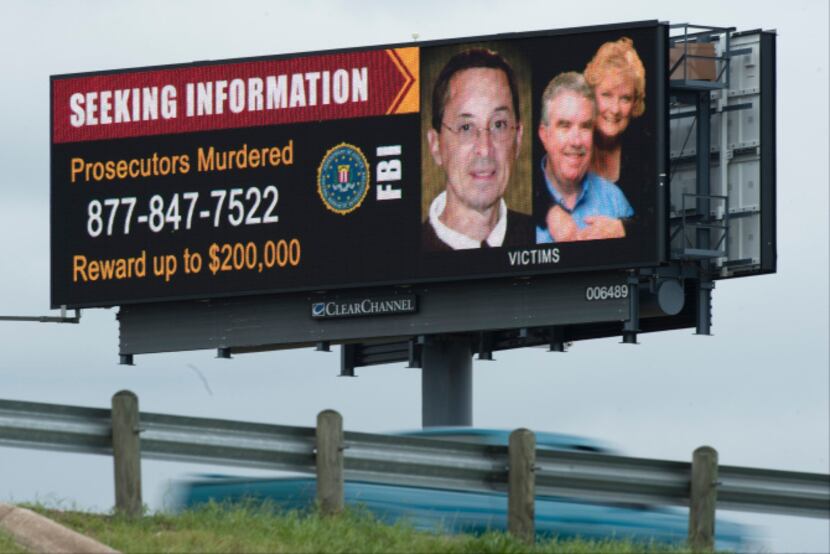 A billboard in Dallas publicizes a reward of up to $200,000 for information about the...