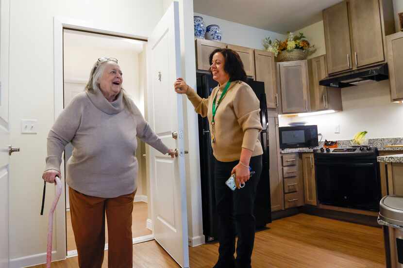 Poldi Tonin (left) walks through the door of her new home at Juliette Fowler Communities in...