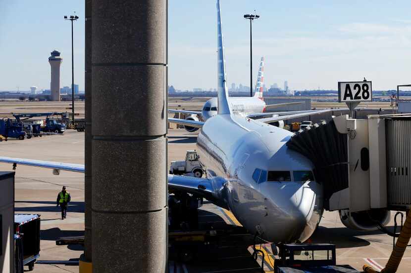 An American Airlines plane is parked at a Terminal A gate at DFW International Airport,...