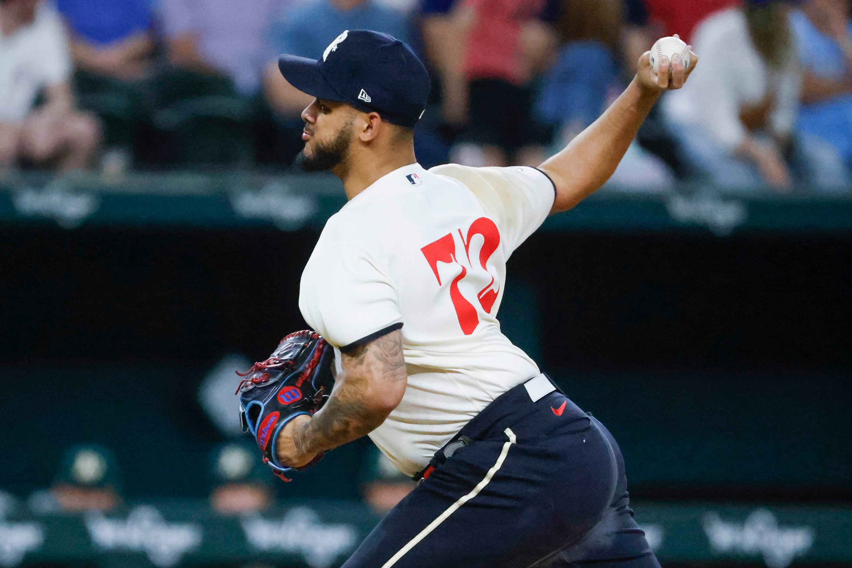 Texas Rangers relief pitcher Jonathan Hernandez throw during a baseball game against Oakland...