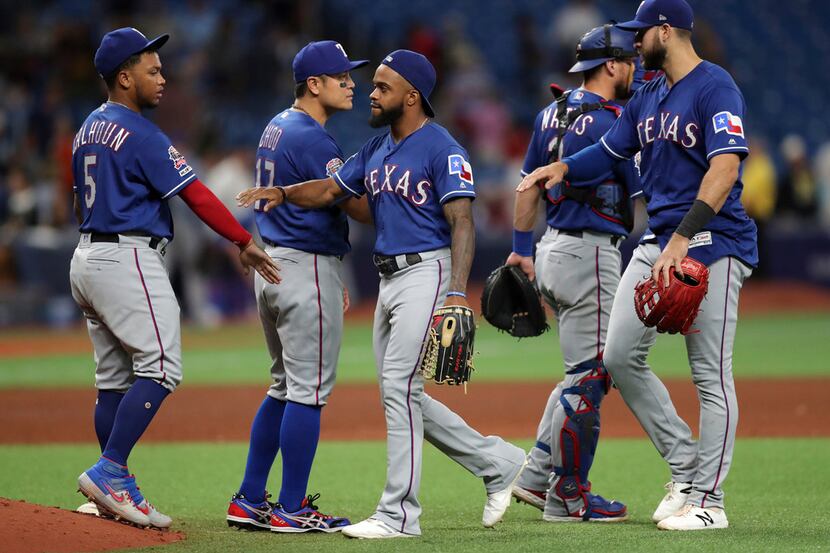 Members of the Texas Rangers celebrate a 5-0 win over the Tampa Bay Rays in a baseball game...