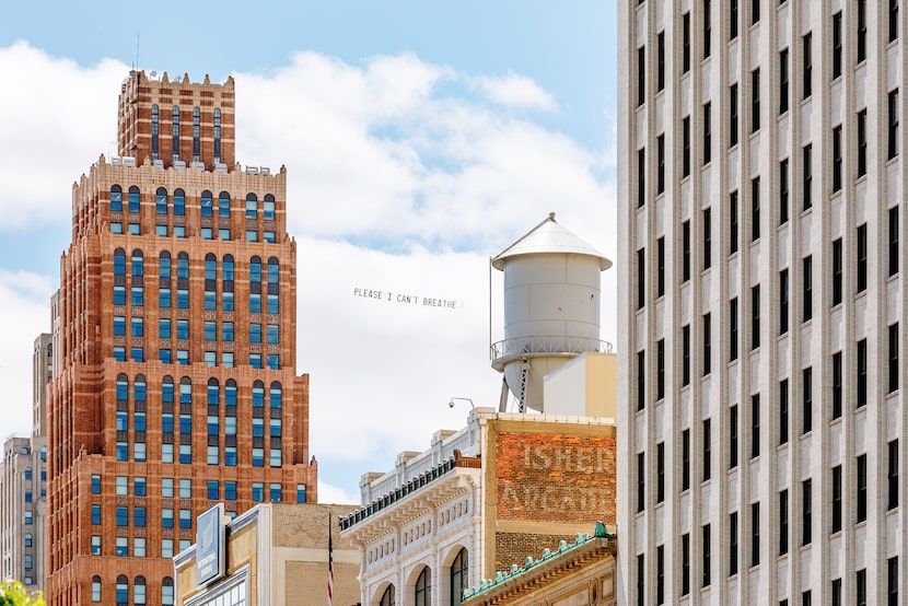 A banner reading "Please I can't breathe," which were among George Floyd's last words,...