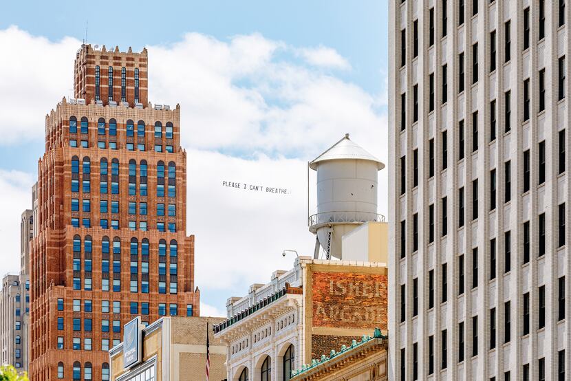 A banner reading "Please I can't breathe," which were among George Floyd's last words,...