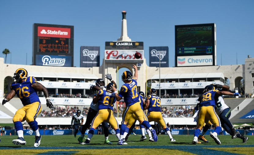 Los Angeles Rams quarterback Case Keenum, center, passes during the second half of an NFL...