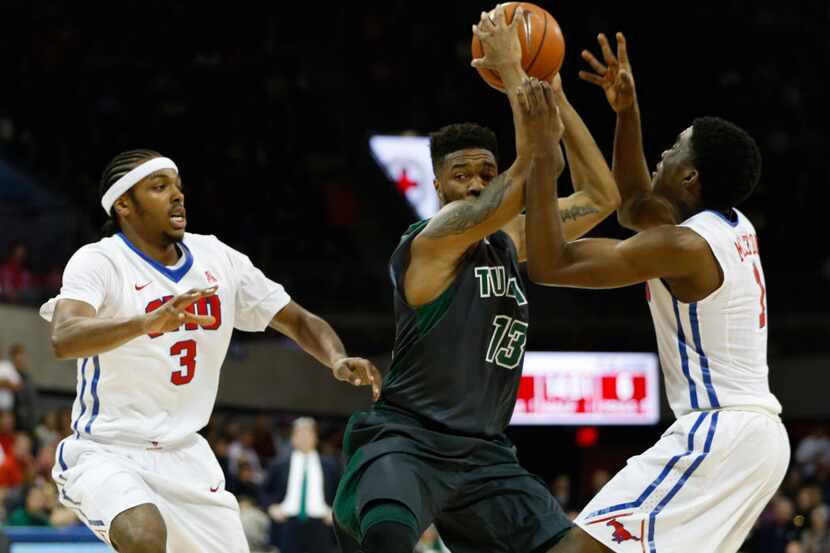 Tulane Green Wave guard Malik Morgan (13) is double teamed by Southern Methodist Mustangs...