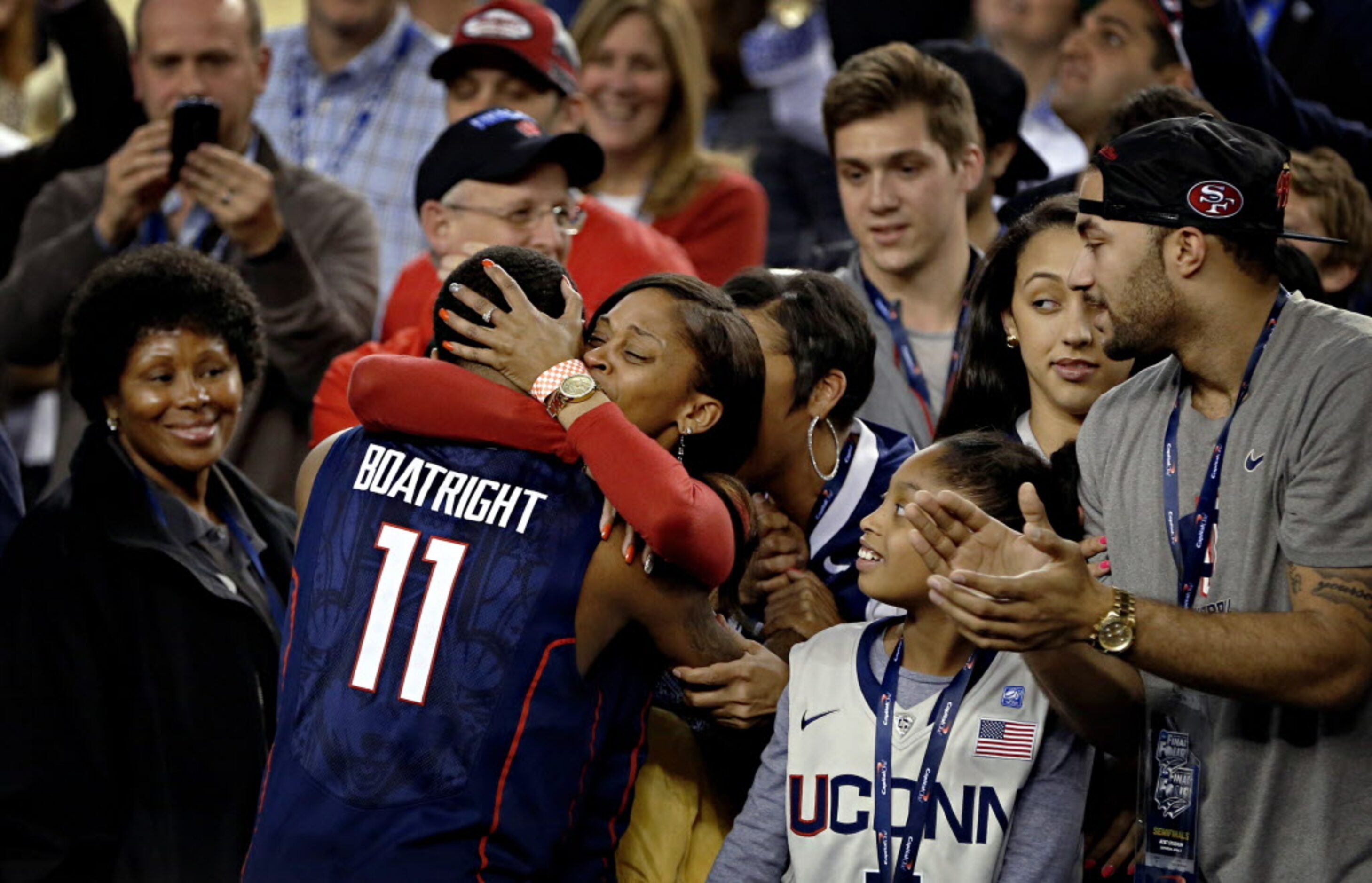 Connecticut Huskies guard Ryan Boatright (11) hugs a family member following a 63-53 win...