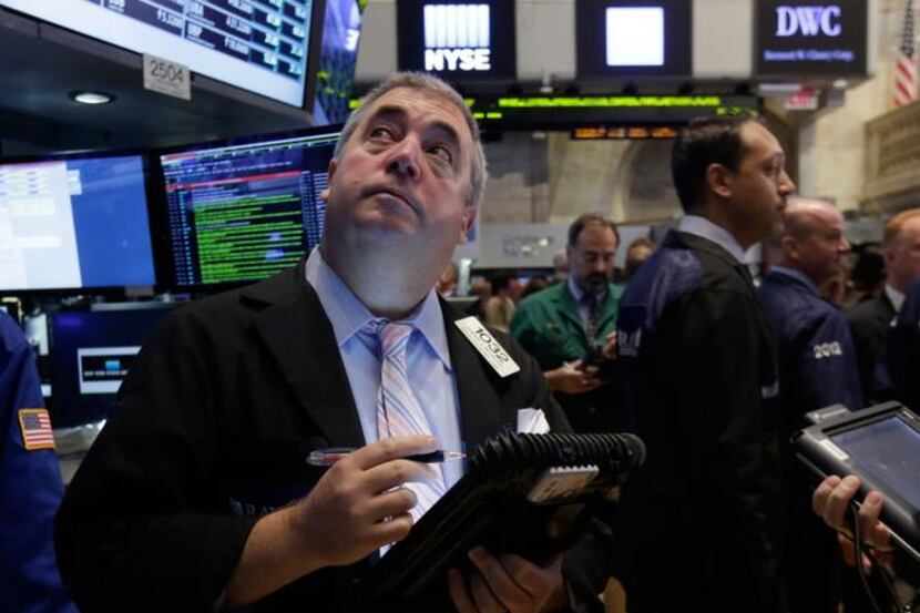 
Trader Edward McCarthy  keeps an eye on stock movements while working on the floor of the...