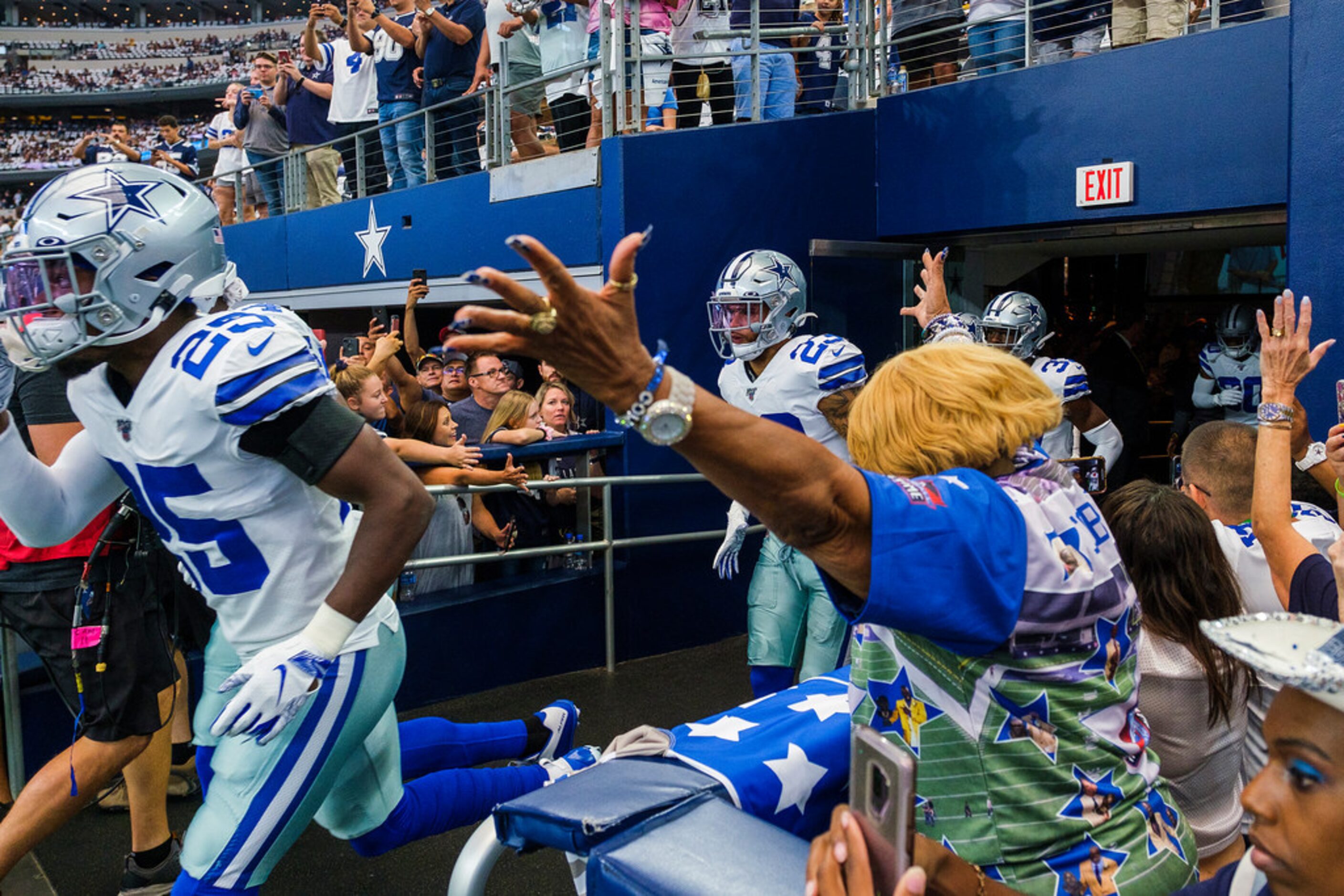 Dallas Cowboys players take the field to warm up before an NFL football game against the...