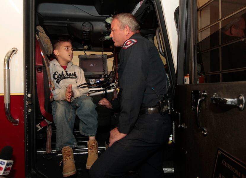 Koregan Quintanilla, 10, of Watauga meets Arlington firefighter Wes Keck as a birthday wish...