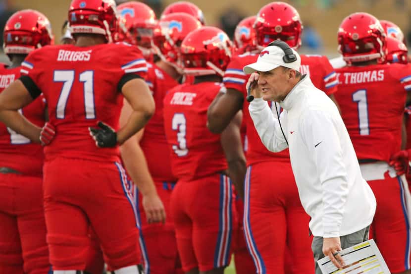 SMU head coach Chad Morris tries to rally his team during the second half of an NCAA college...