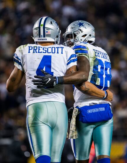Cowboys quarterback Dak Prescott hugs Dez Bryant after they hooked up for a touchdown Sunday...