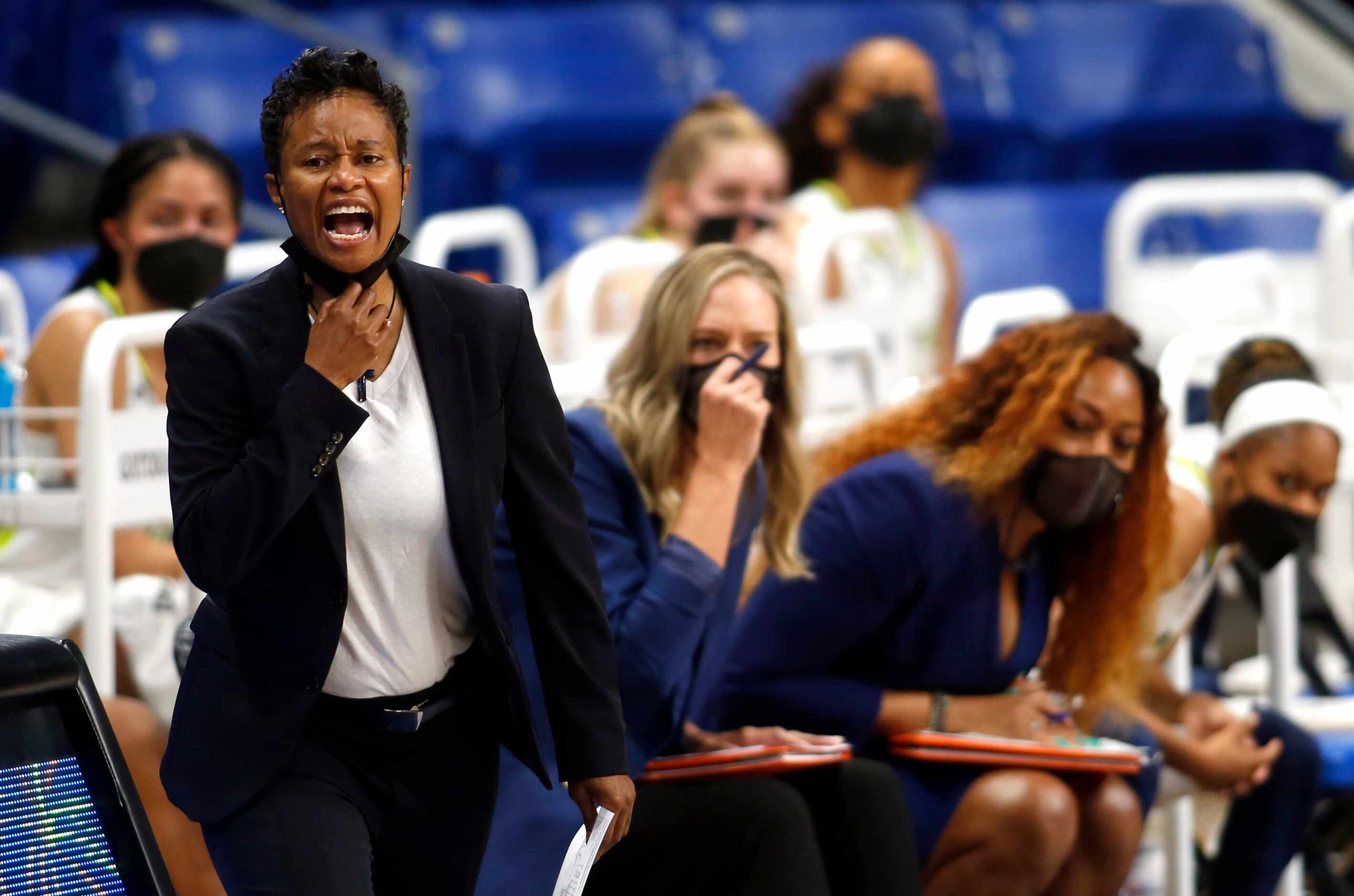 Dallas Wings head coach Vickie Johnson directs her players from the team bench area during...