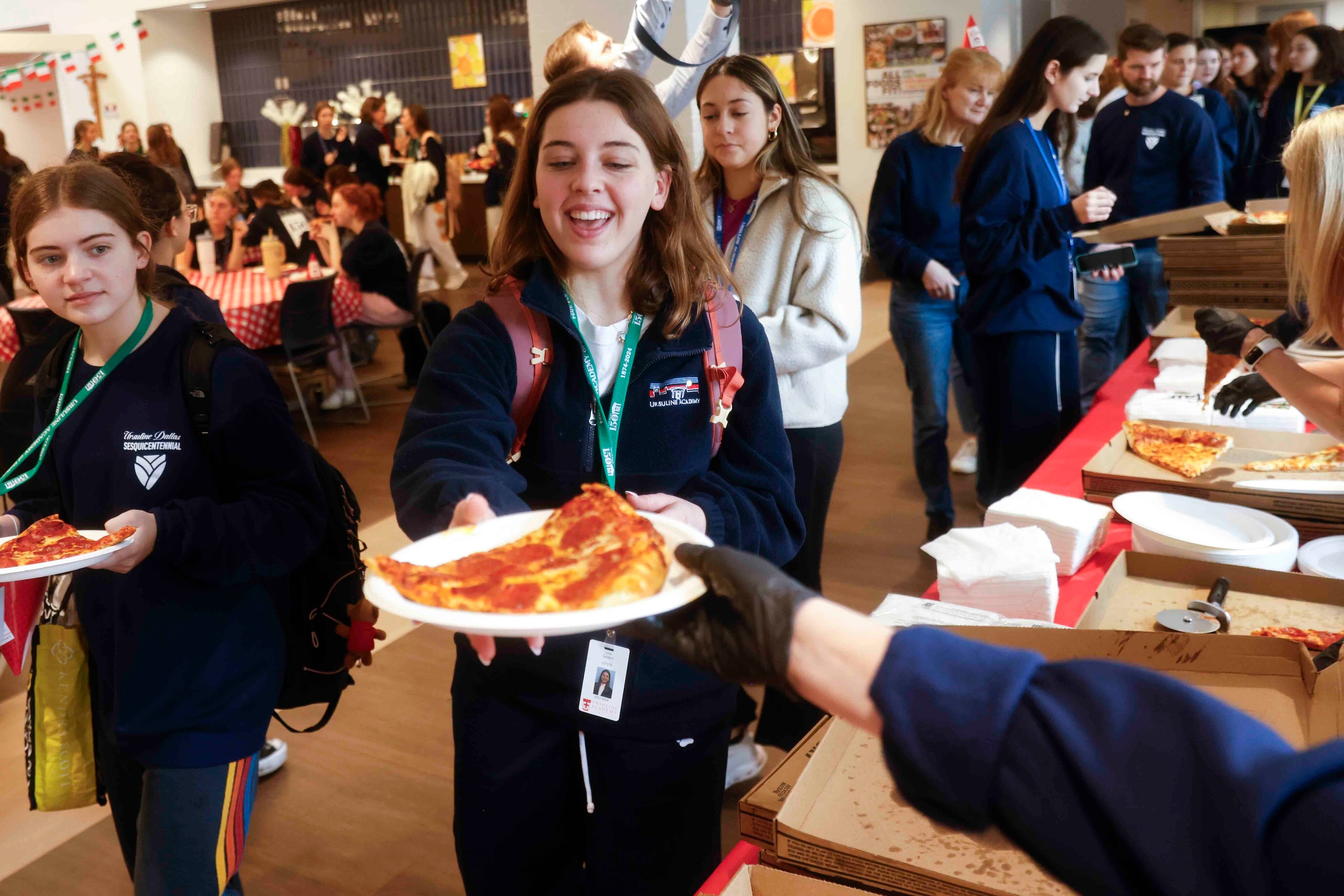 Student Lucy Sanders reacts while getting her pizza for lunch during the 150th anniversary...