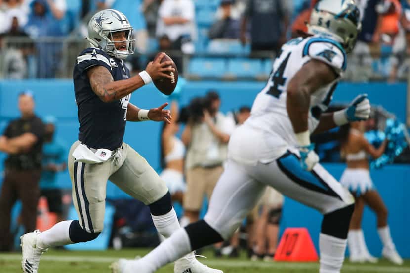 Cowboys quarterback Dak Prescott (4) looks to pass during a game against the Panthers on...