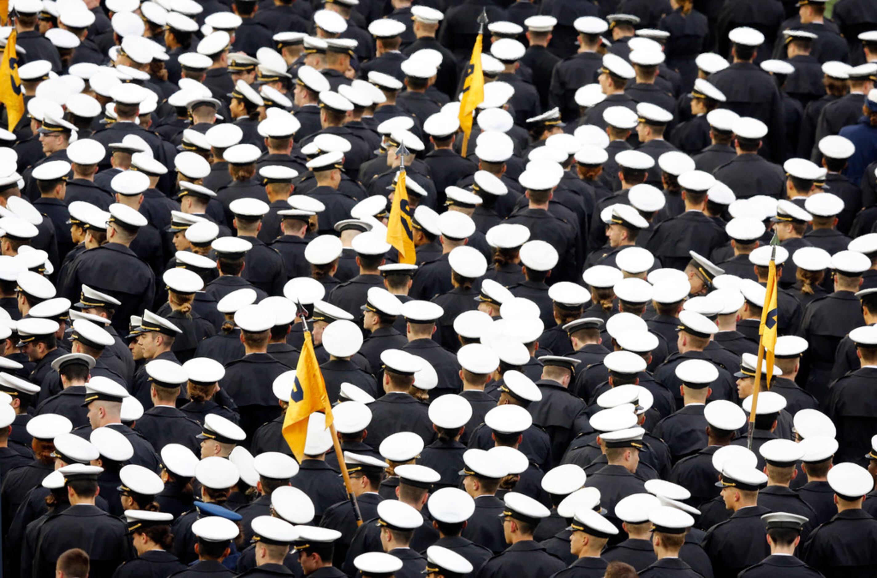 Navy Midshipmen exit the field after pregame ceremonies and the national anthem at...