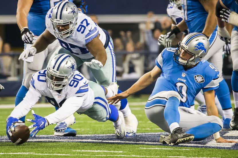 Dallas Cowboys defensive end DeMarcus Lawrence (90) recovers a fumble by Detroit Lions...