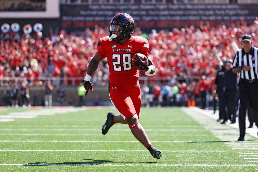 Texas Tech's Tahj Brooks (28) runs to score a touchdown during the first half of an NCAA...