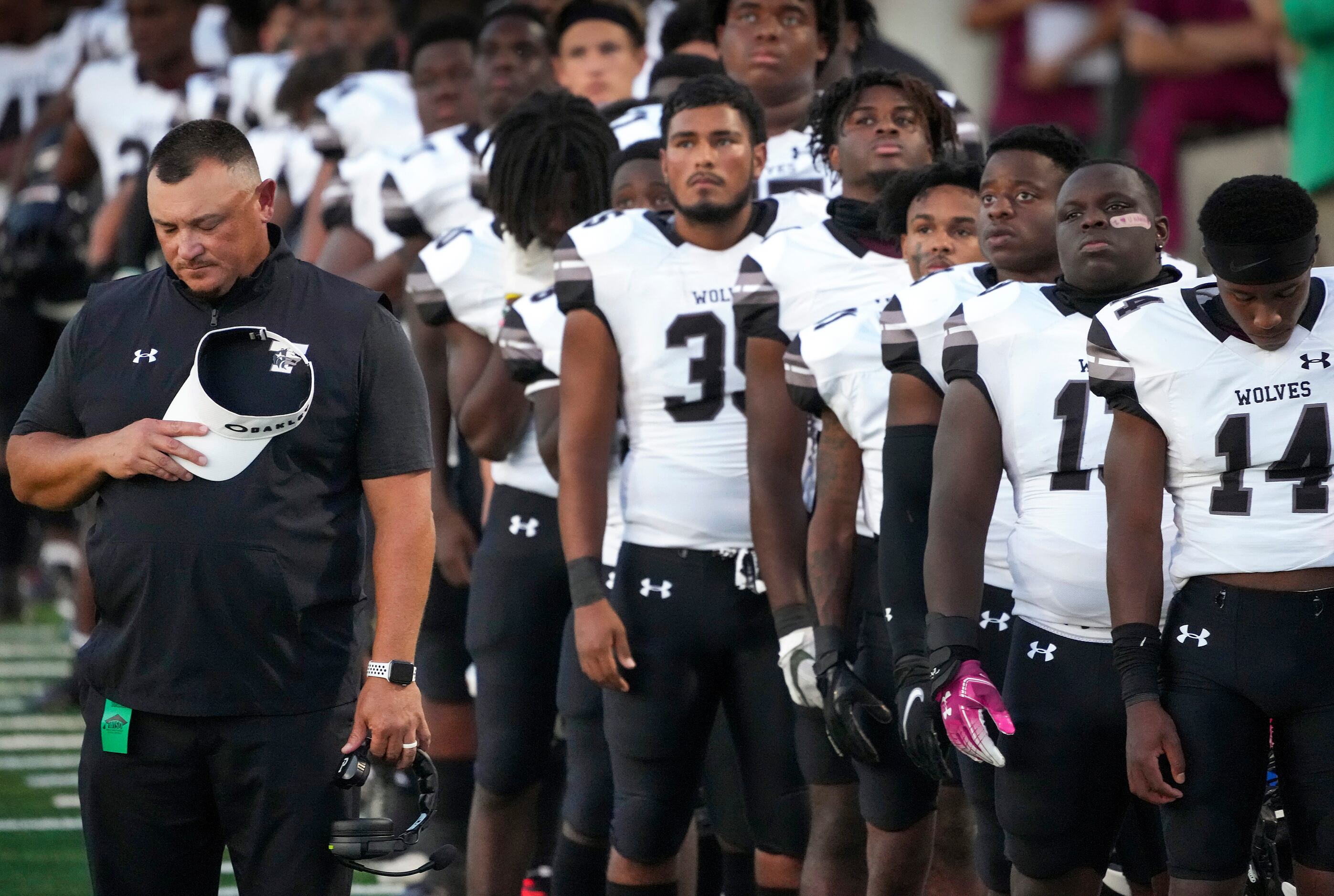 Mansfield Timberview head coach James Brown stands his his players for a moment of silence...