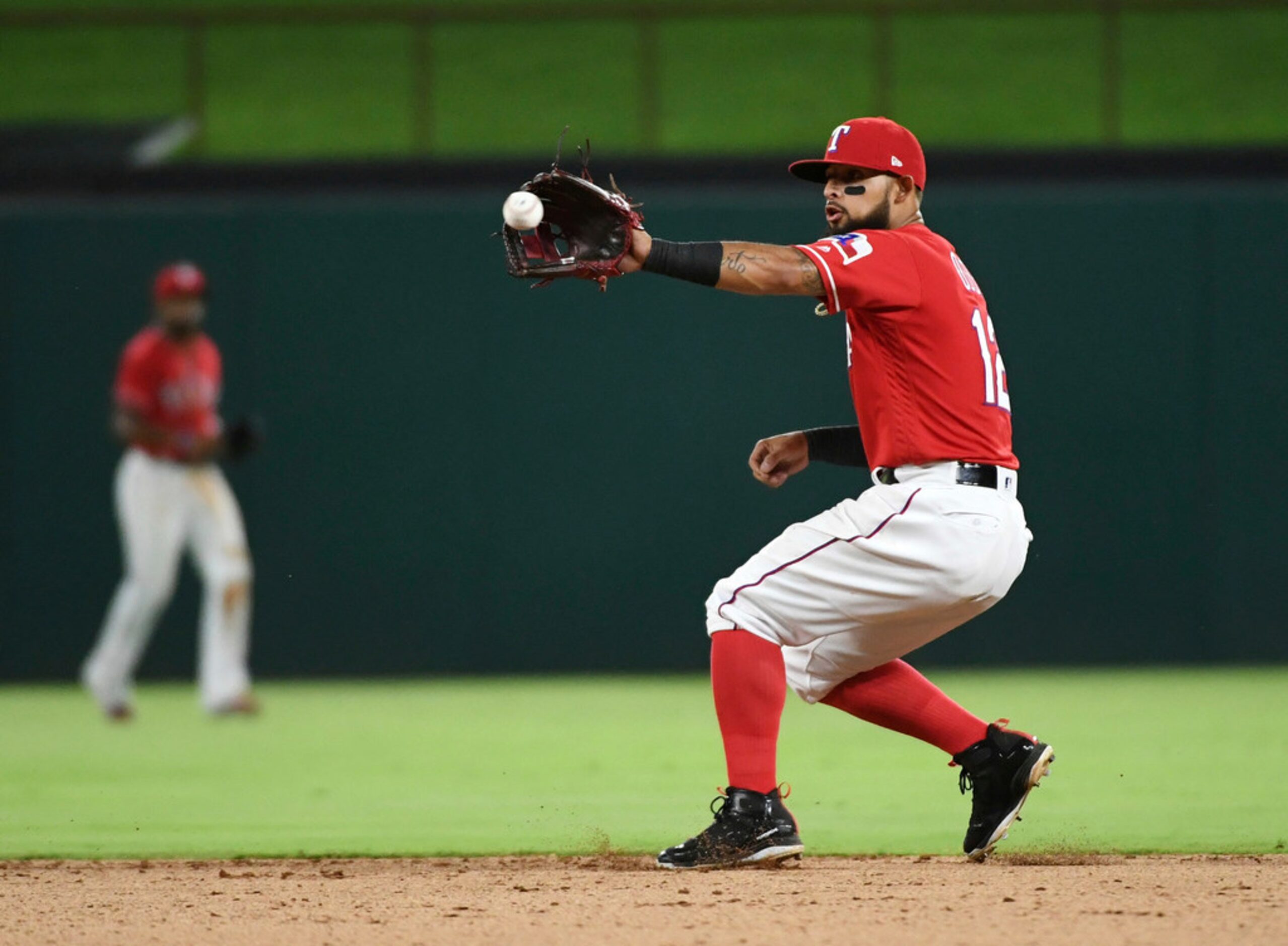 Texas Rangers second baseman Rougned Odor fields a grounder by Chicago White Sox's Charlie...