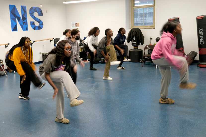 Hillary Amofa (second from left), practices with members of the Lincoln Park High School...