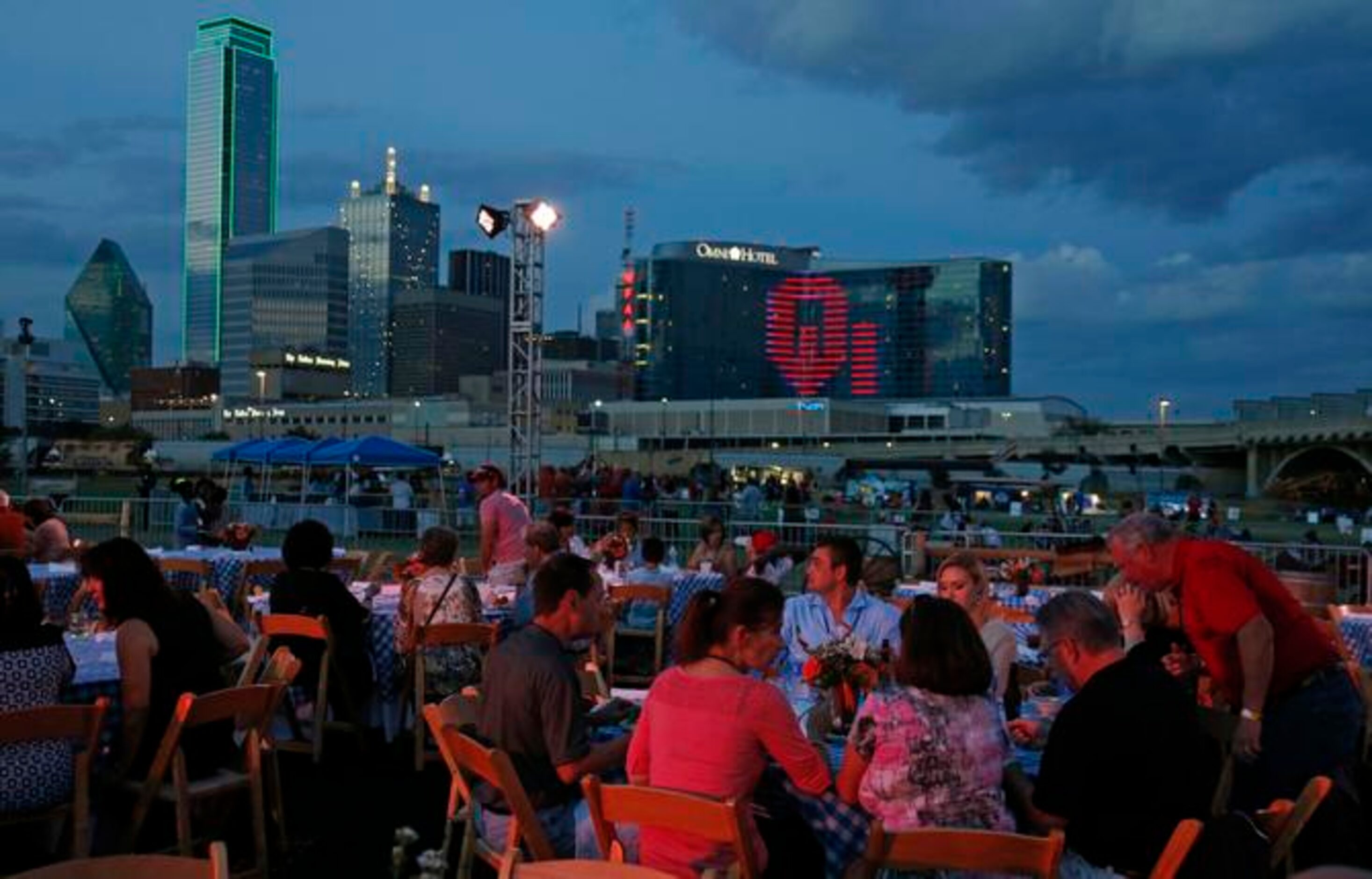 
Diners enjoy dinner at dusk as part of the "Celebrate Texas-OU Weekend" activities at the...