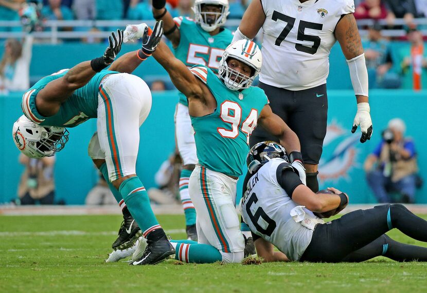 Miami Dolphins defensive ends Cameron Wake (91) and Robert Quinn (94) celebrate sacking...