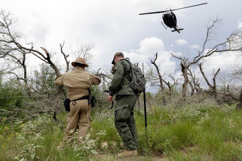 An U.S. Customs and Border Protection Borstar Agent and Air and Marine agent look for signs...