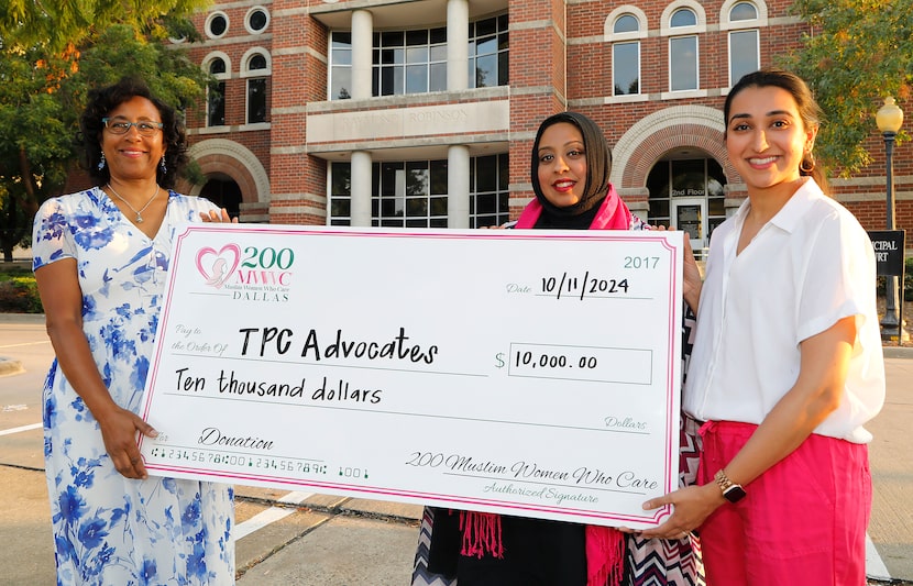 Texas Prisons Community Advocates president Amite Dominick (left), receives a check from...