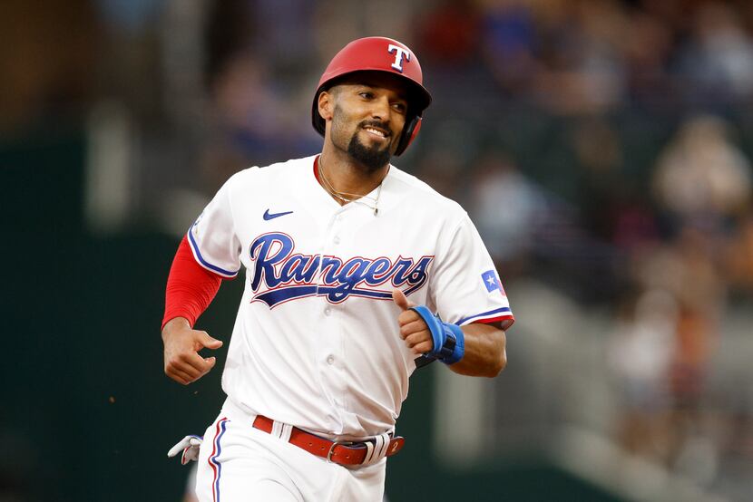 Texas Rangers second baseman Marcus Semien (2) smiles as he rounds the bases after shortstop...