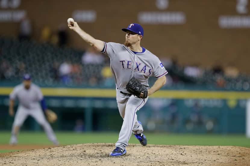 Texas Rangers relief pitcher Sam Dyson throws during the ninth inning of a baseball game...