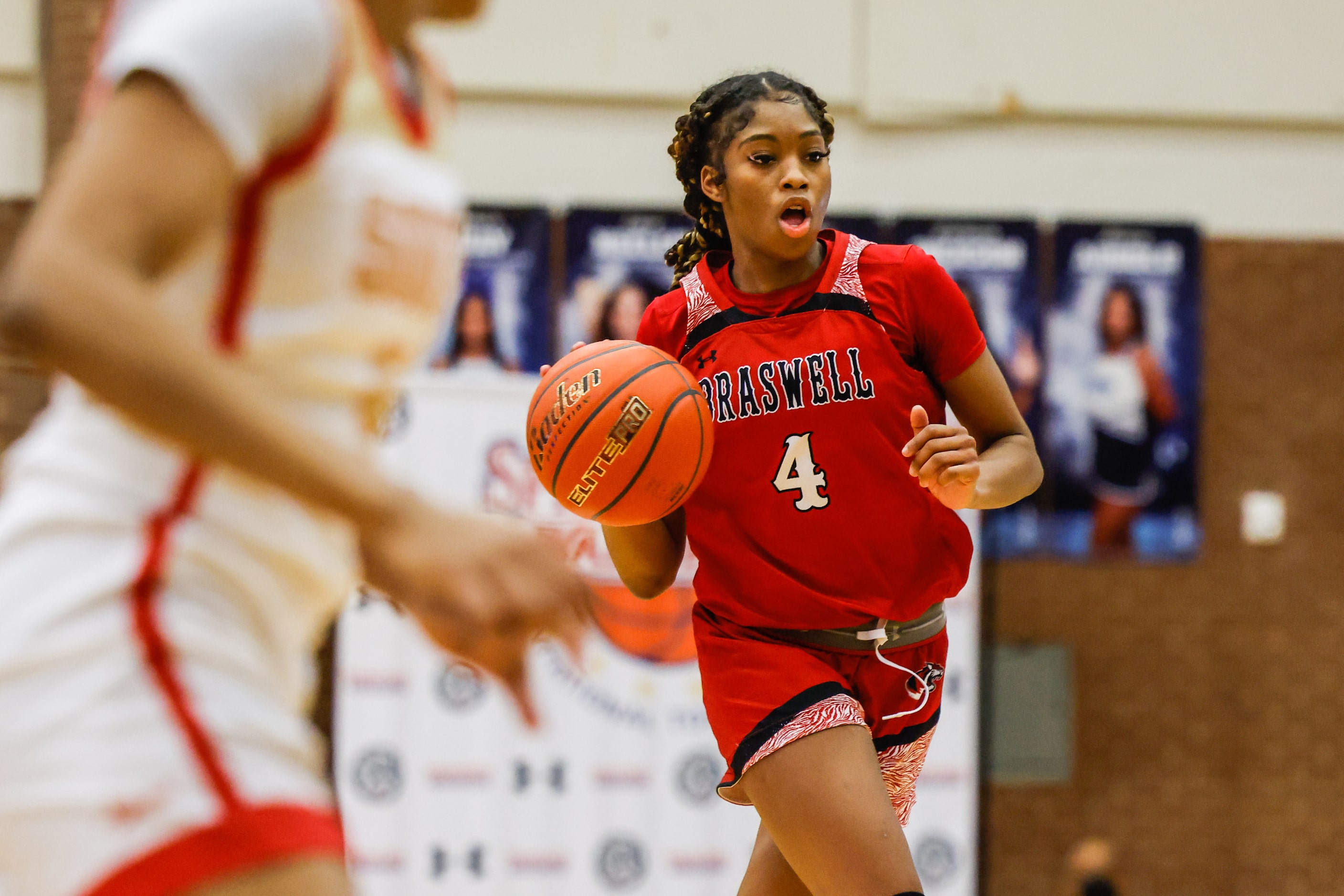 Denton Braswell's Kennedy Evans (4) dribbles the basketball against South Grand Prairie...