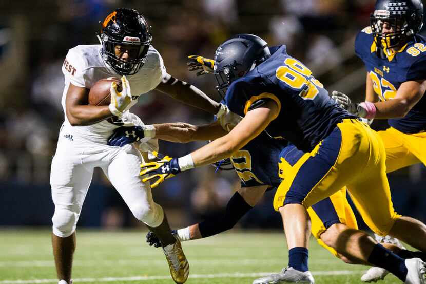 West Mesquite running back Curtis Williams (6) is tackled by Highland Park defensive back...