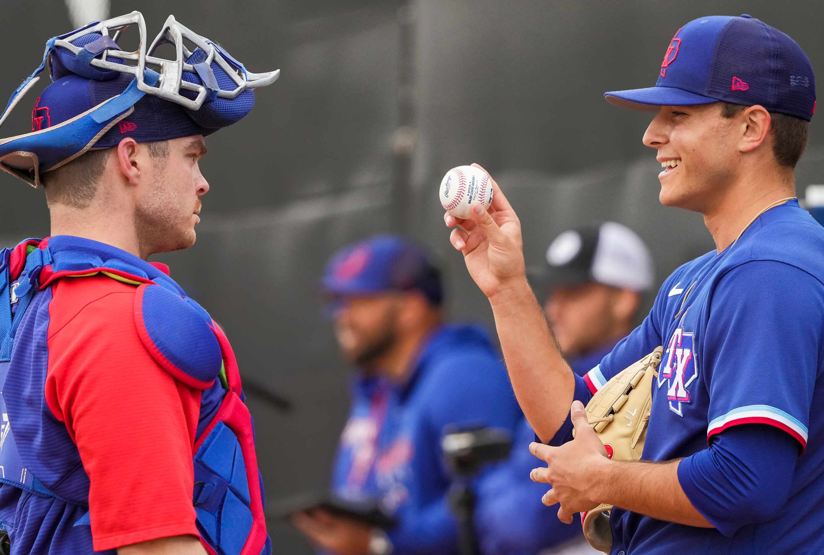 Texas Rangers pitcher Jack Leiter talks with catcher Matt Whatley after throwing in a...