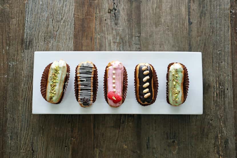 Finished eclairs topped with chocolate and flavored glazes. 