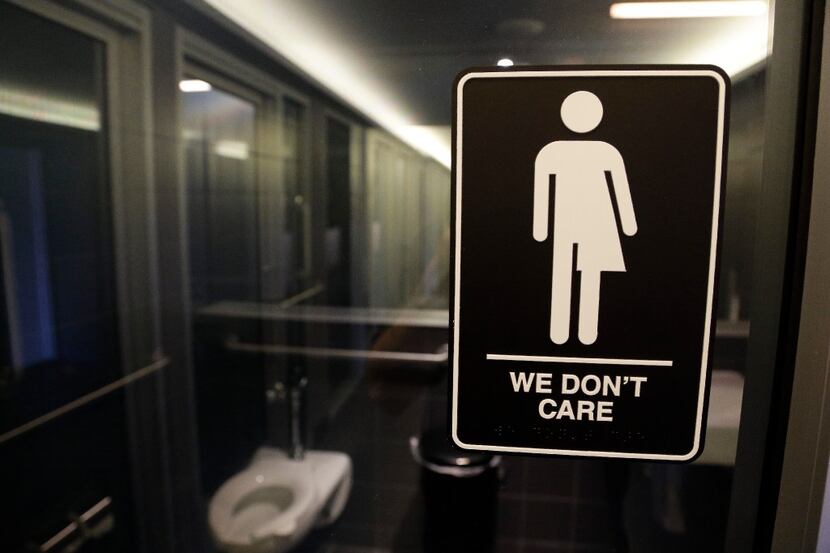 FILE - This Thursday, May 12, 2016, file photo, shows a sign outside a restroom at 21c...