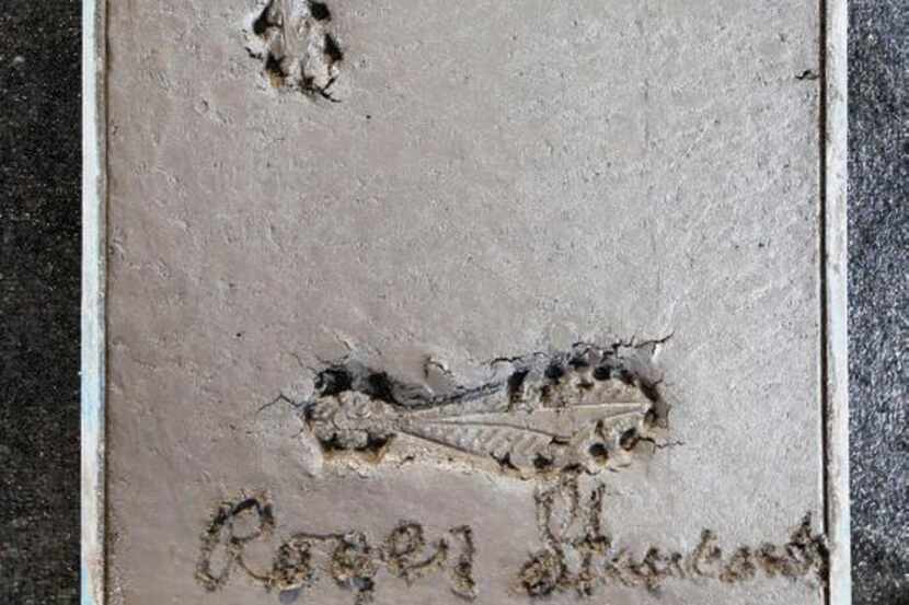 Former Dallas Cowboys Roger Staubach foot imprint and signature in cement during a press...