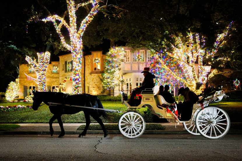 People ride a horse carriage from North Star Carriages in Highland Park in December 2023....