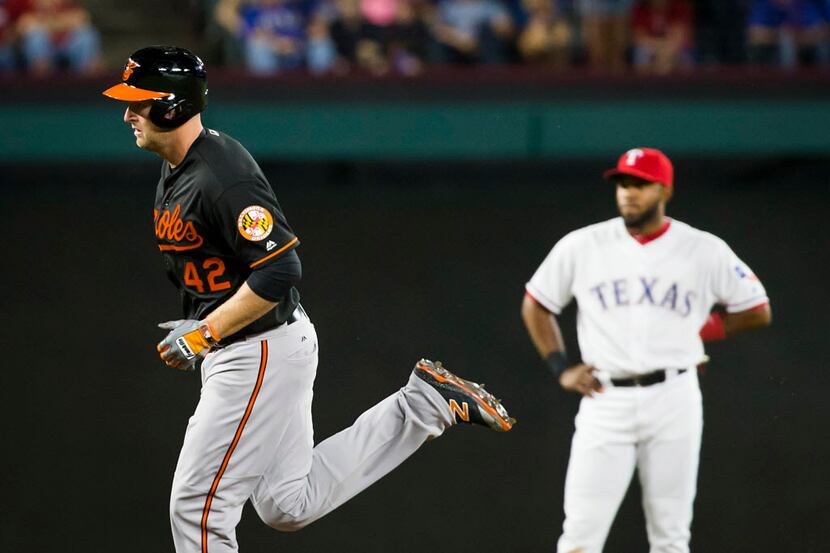 Baltimore Orioles designated hitter Mark Trumbo rounds the bases past Texas Rangers...