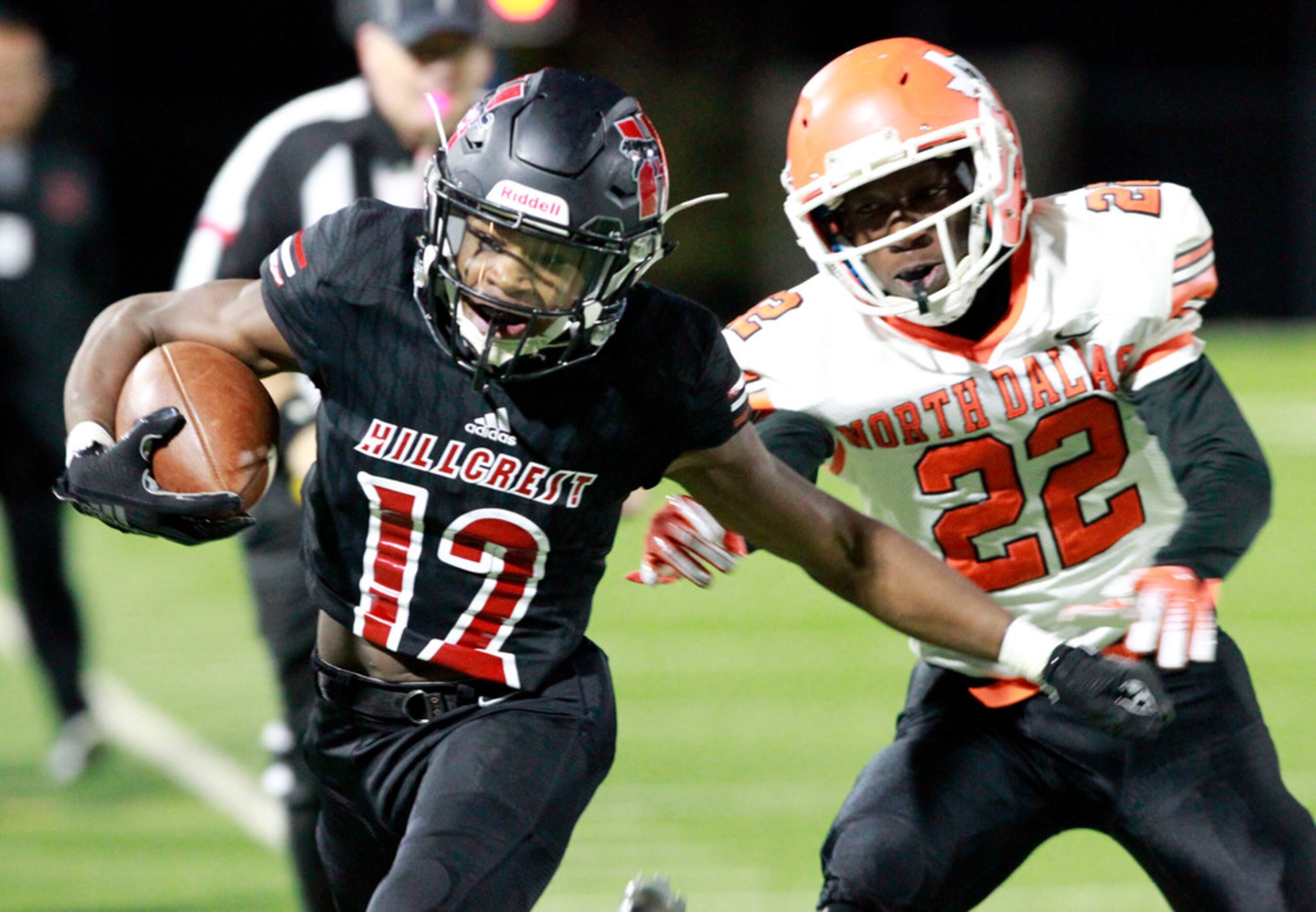 Hillcrest's Zion Cornelius (12) is pushed out of bounds by North Dallas' Trevion Smith (22),...