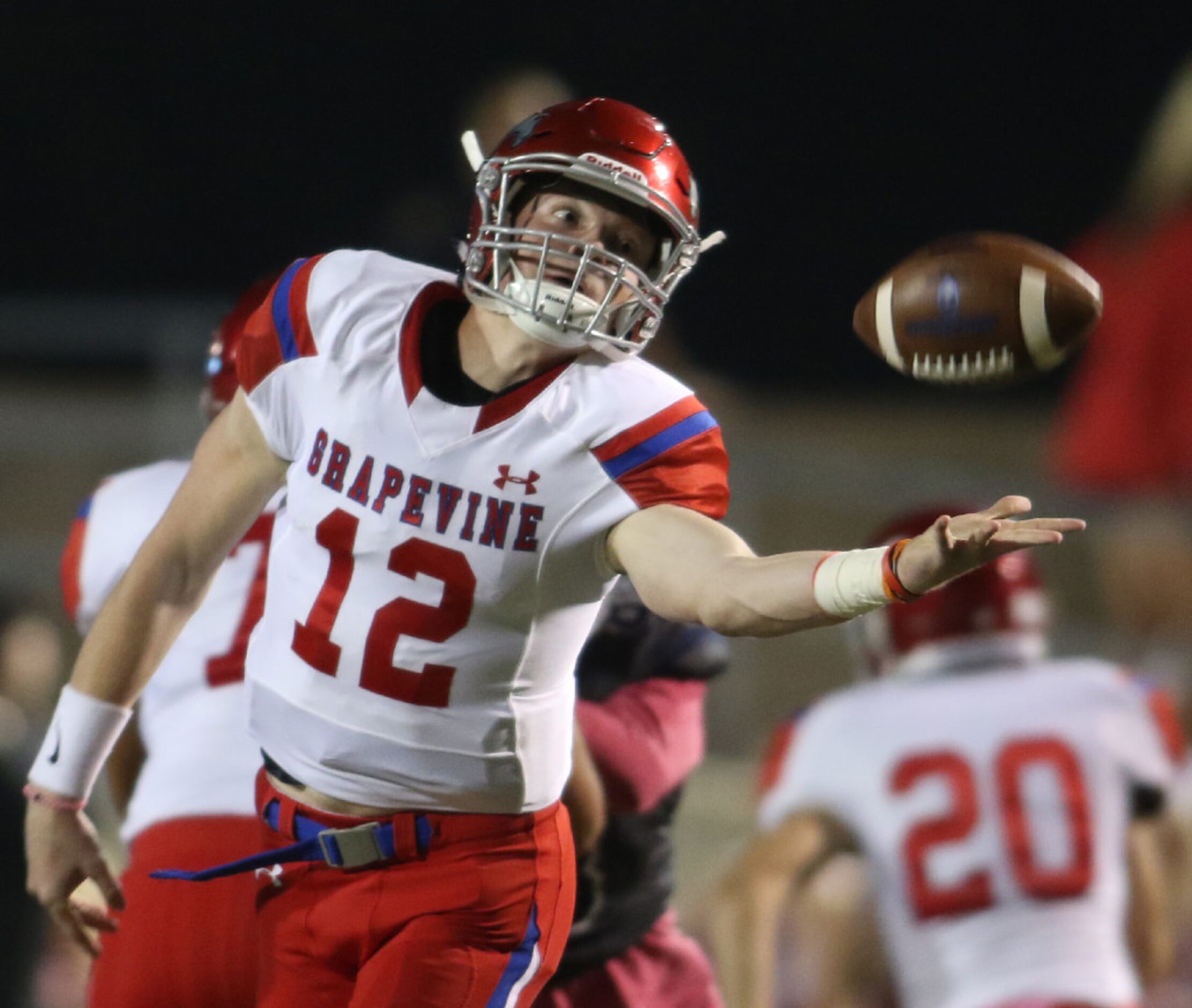 Grapevine quarterback Alan Bowman (12) reaches to pull in a high snap from center that...