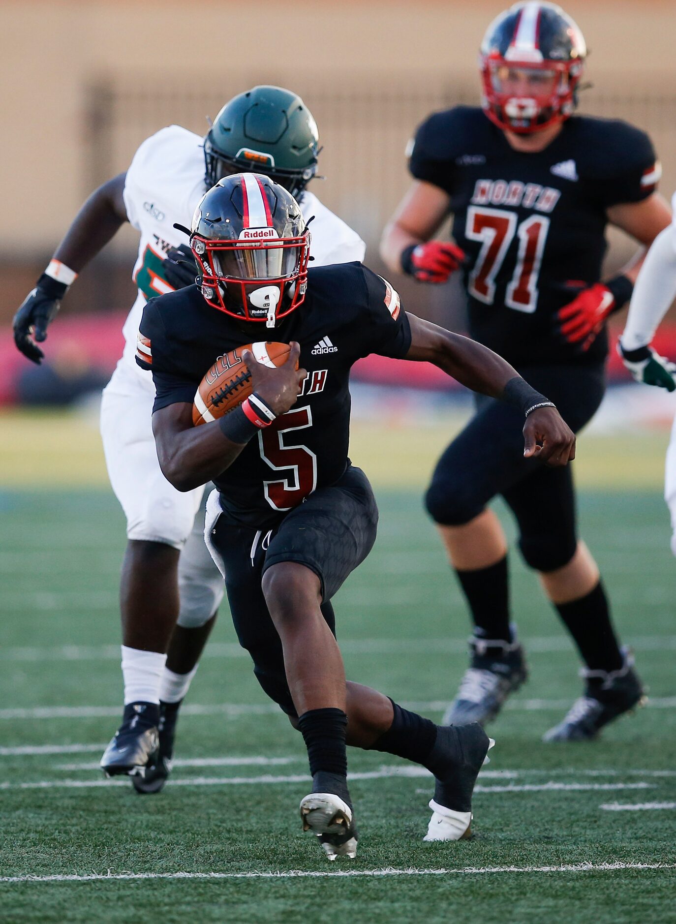 North Garland sophomore quarterback Godspower Nwawuihe (5) looks for room against the...