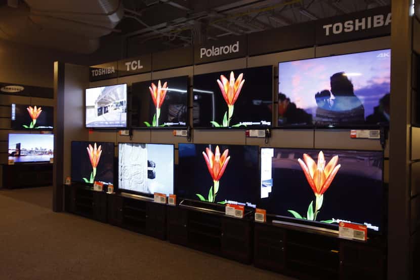 Televisions, ready for sale at the Nebraska Furniture Mart in The Colony, need to be...