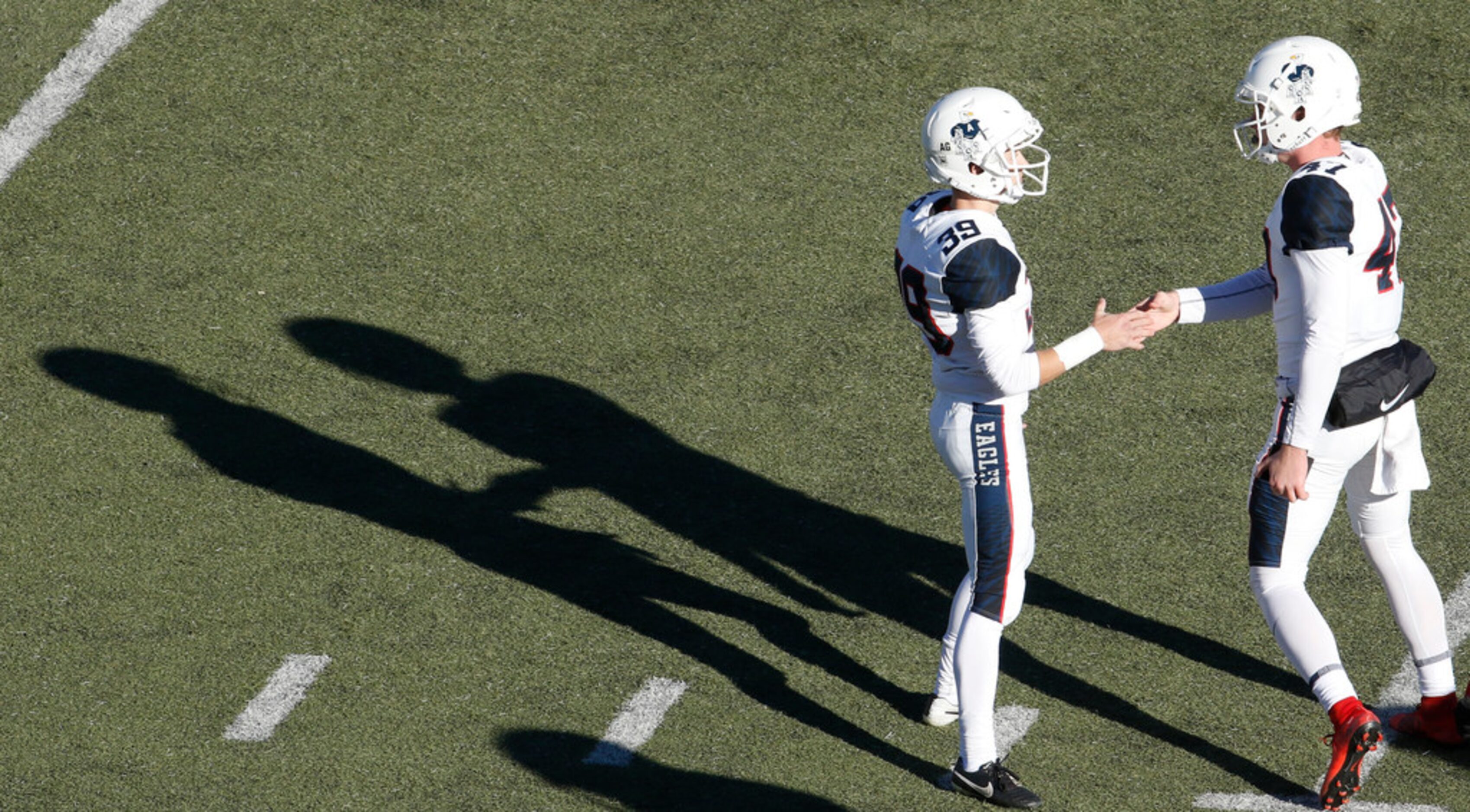 Allen kicker Brady Ellsworth (39) shares a handshake with holder Jake Grimes (47) as their...