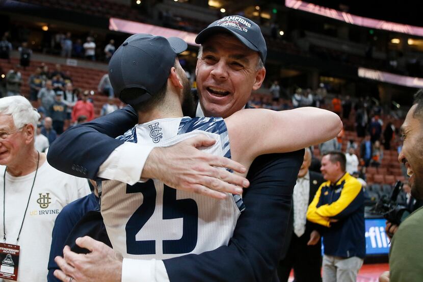 UC Irvine head coach Russell Turner, right, celebrates with guard Spencer Rivers (25) after...