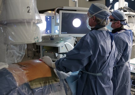 A doctor for North American Spine, left, and a physician's assistant perform a minimally...