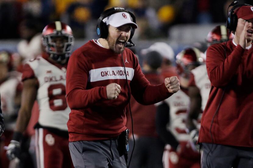 Oklahoma coach Lincoln Riley celebrates a touchdown during the first half of the team's NCAA...
