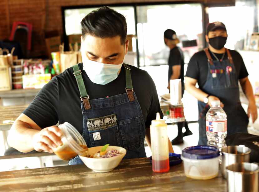 Donny Sirisavath, left, prepares the Khao Poon at Khao Noodle Shop in Dallas.