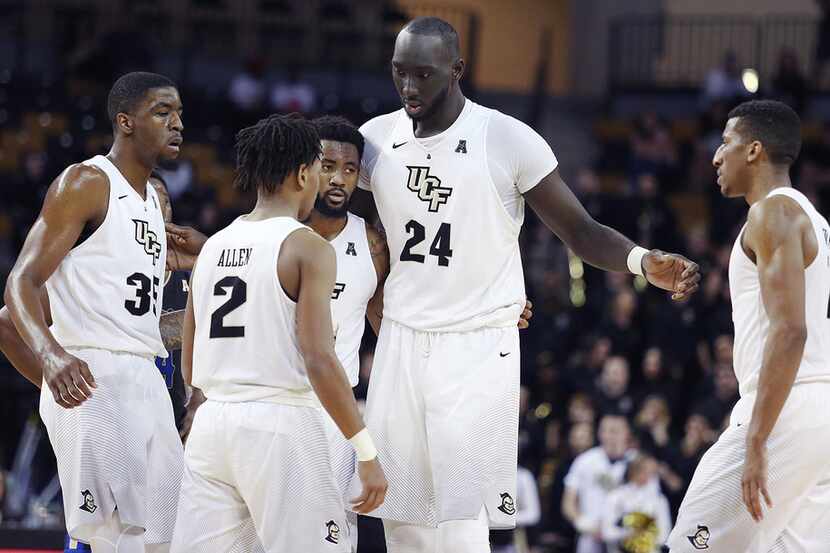 UCF's Tacko Fall (24) gathers teammates for a huddle during action against Tulsa at CFE...